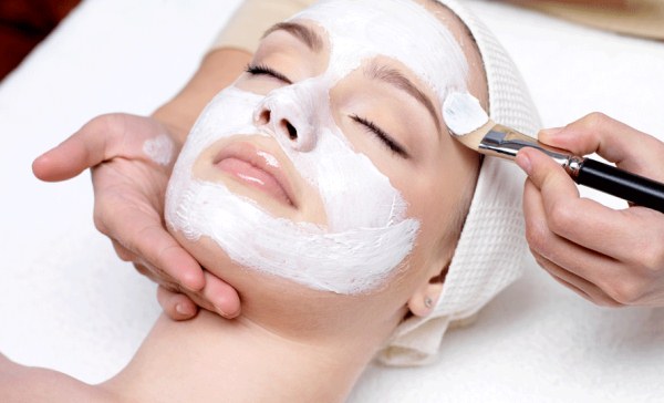 Summer facial treatments by a beautician