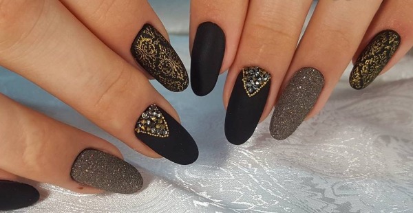 Nail design in black, with black varnish, gold, silver, rhinestones. New items and photos