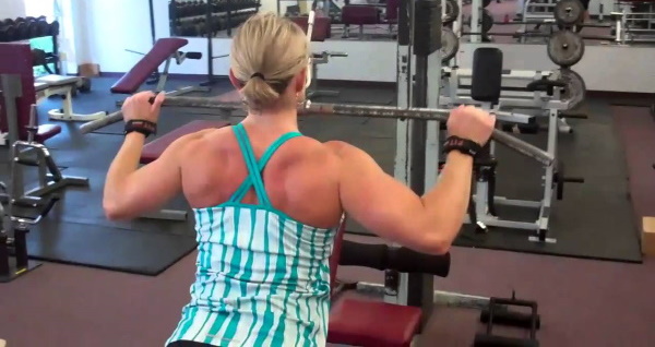 Exercise machine vertical pull. Technique for sitting, on the back, behind the head, with a narrow grip for women