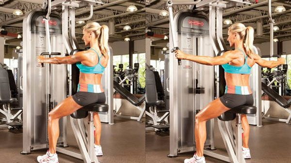 Exercises for the rear deltas in the gym in a crossover for girls