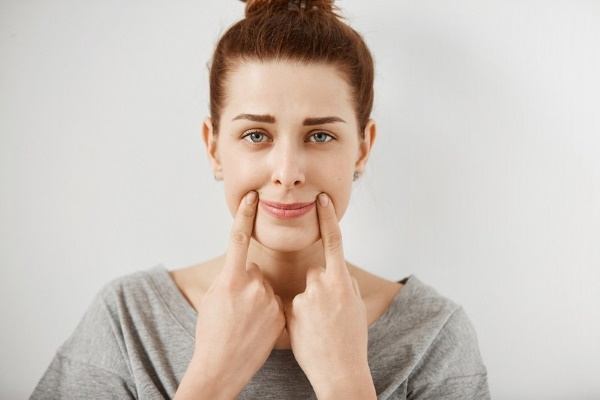 A dimple on the girl's chin. Photo, meaning, how to get rid